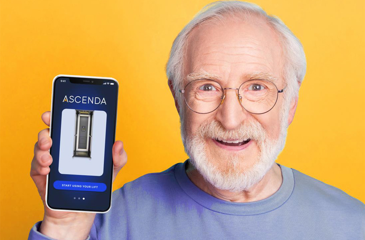 Smiling older man holding a smartphone showing the Ascenda App screen for controlling a home lift.