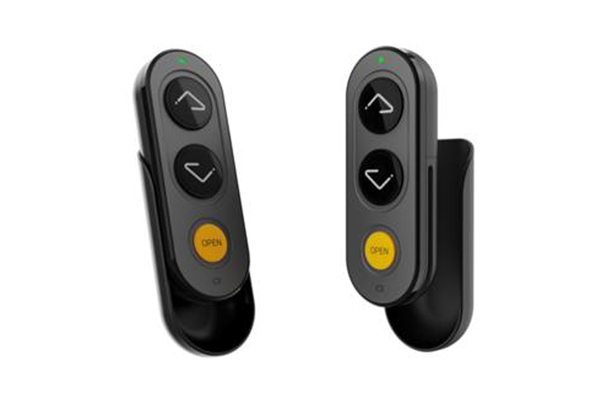 Pair of black wall-mounted wireless remotes for the Ascenda lift, each with up, down, and yellow OPEN buttons.