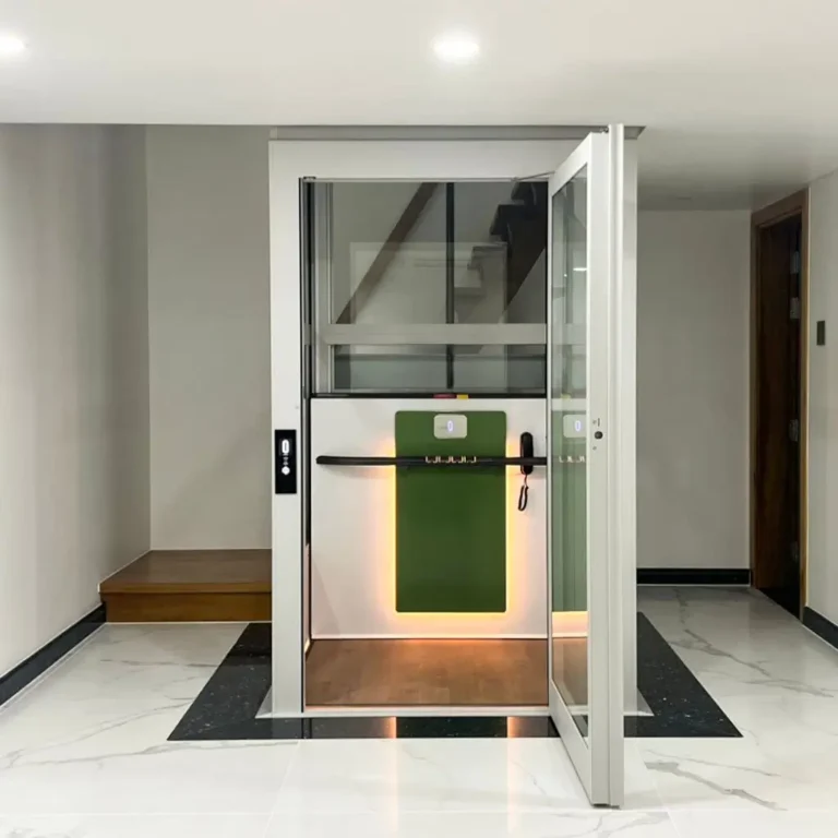 Cibes Air home lift with glass shaft and green back panel installed in the middle of a staircase inside a modern villa.