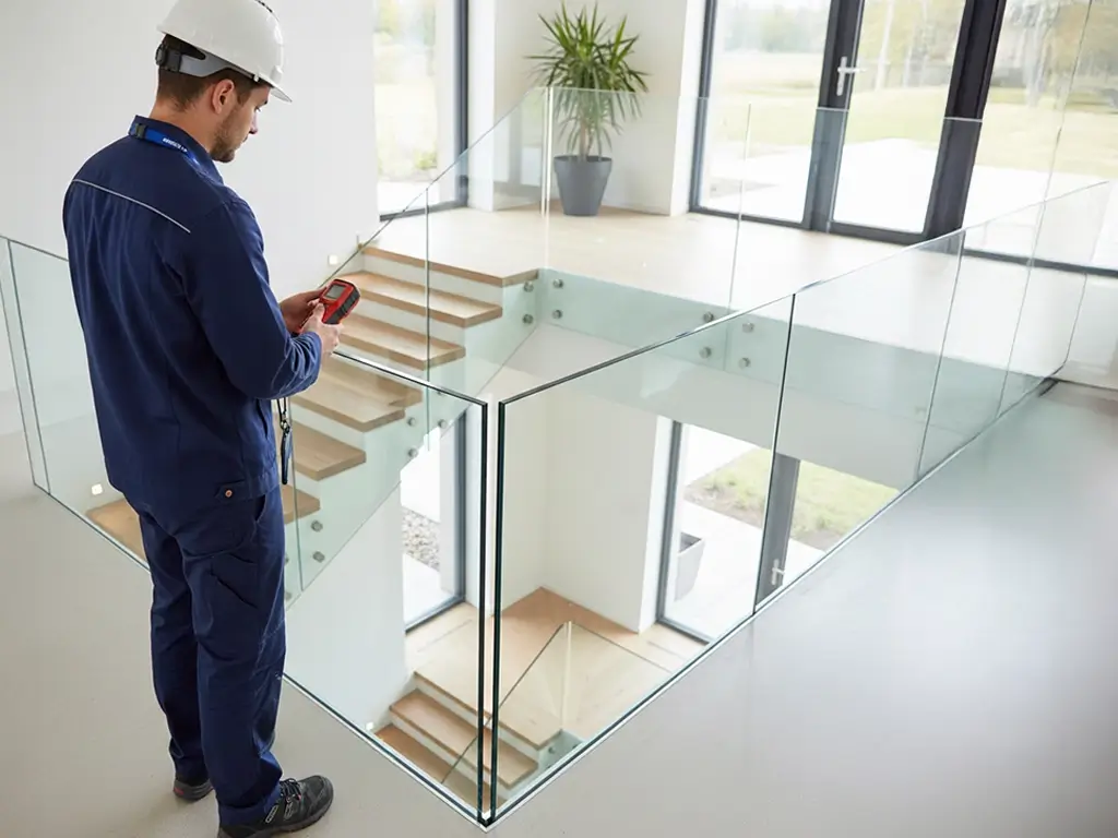 Cibes technician measuring travel height inside a villa as part of the home lift installation process.