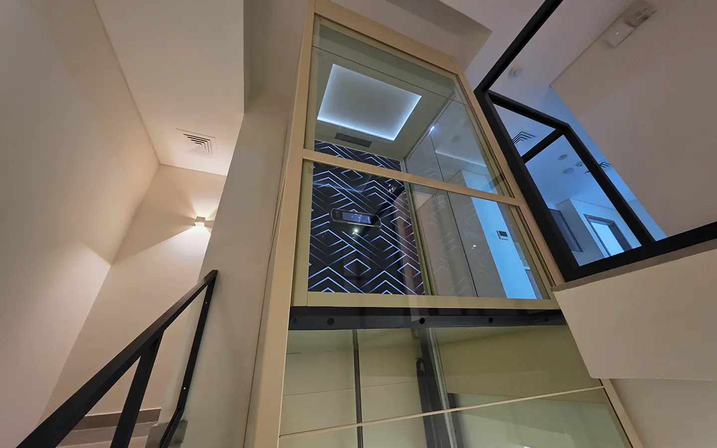 Modern glass home lift installation inside a UAE villa featuring a Cibes V90 cabin with panoramic shaft design.