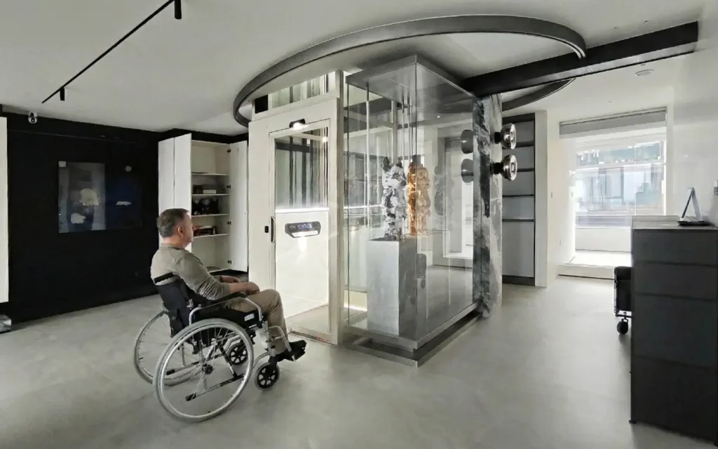 Wheelchair user approaching a modern home lift installation inside a UAE villa living space for safe and independent access between floors.