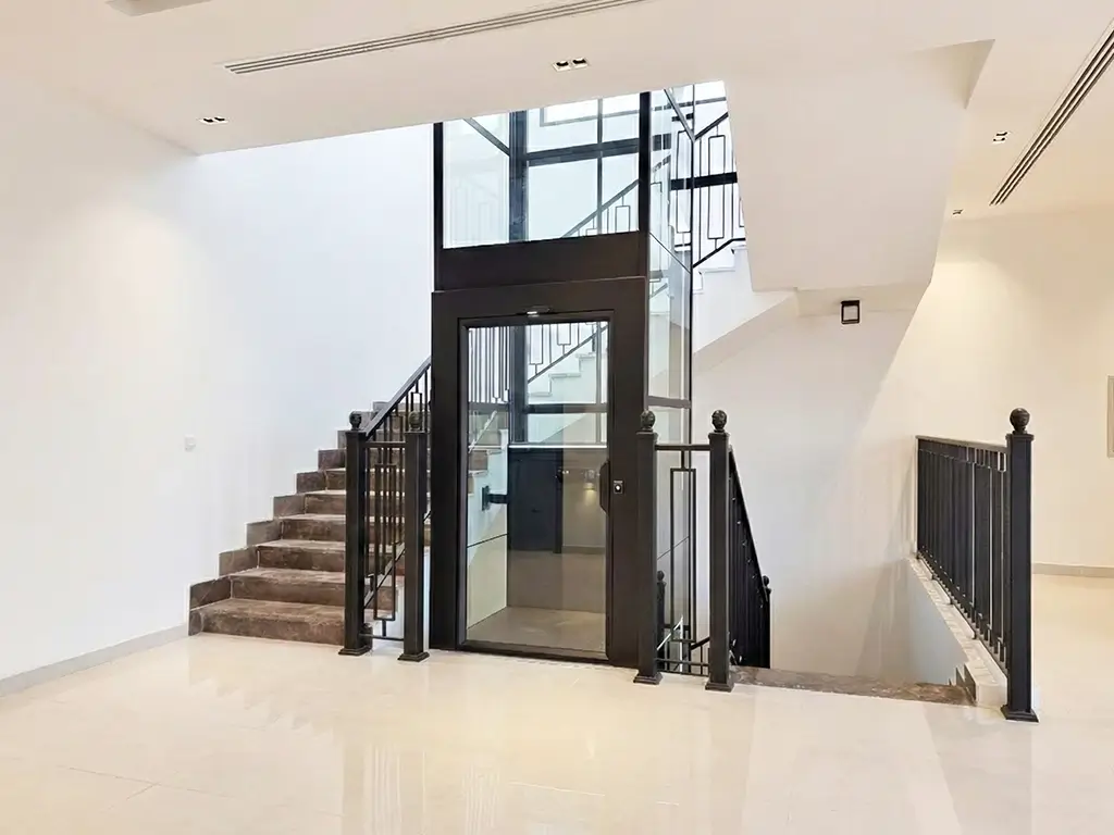 3-stop home lift installation in Abu Dhabi featuring a Cibes V80 Aurora platform lift integrated beside a staircase.