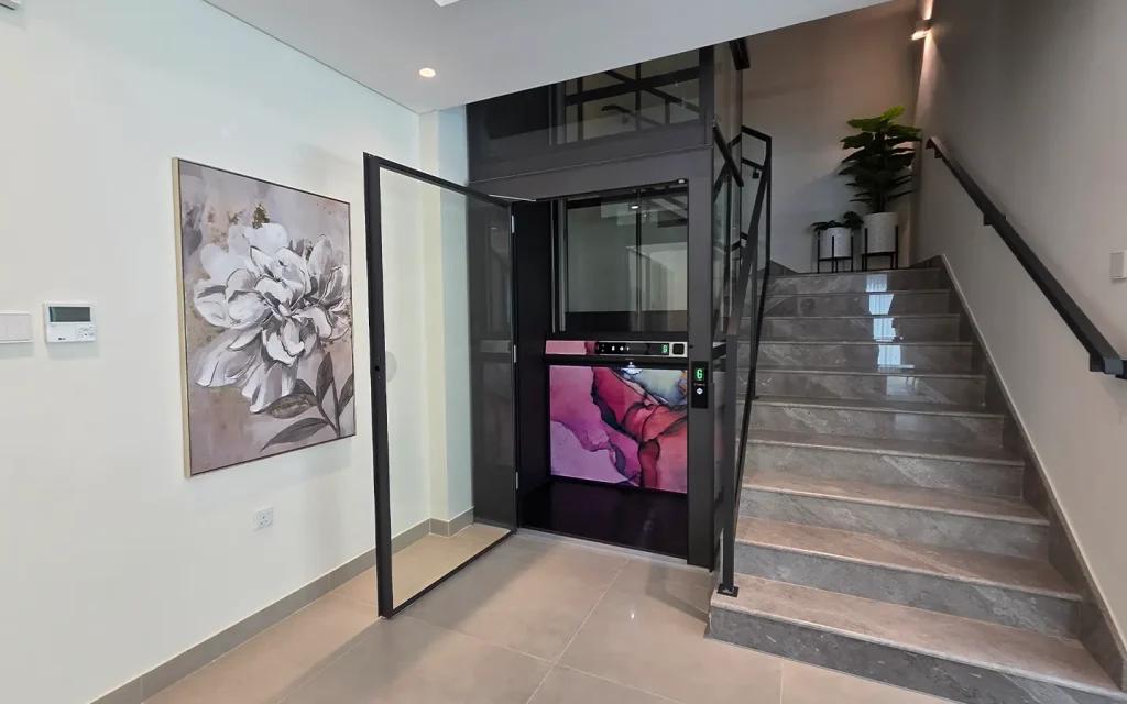 Indoor home lift installed beside staircase inside a modern villa in the UAE.