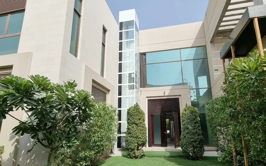 Outdoor home lift installed on the exterior wall of a modern villa in the UAE.